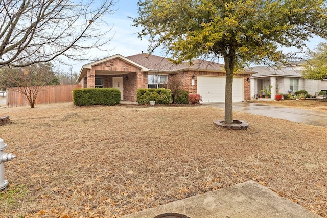 ranch-style house featuring a garage and a front lawn