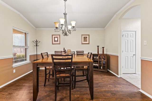 dining room featuring crown molding, a chandelier, and dark hardwood / wood-style flooring