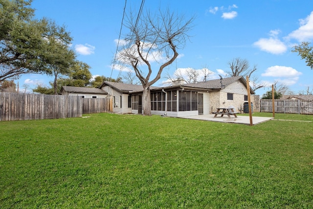 back of property featuring a patio, a yard, a fenced backyard, and a sunroom