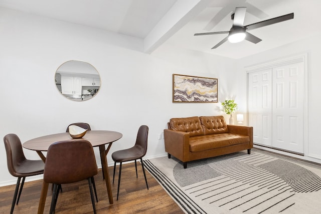 dining space with dark wood-style floors, ceiling fan, and baseboards