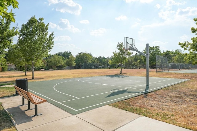 view of basketball court featuring community basketball court and fence