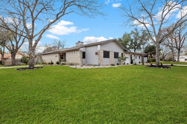 rear view of property with a lawn