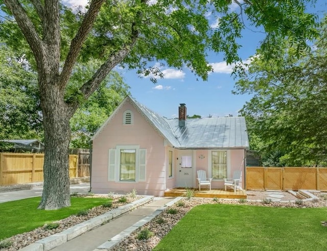 rear view of property with a lawn