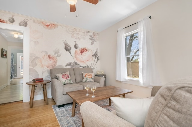 living room with ceiling fan and light wood-type flooring