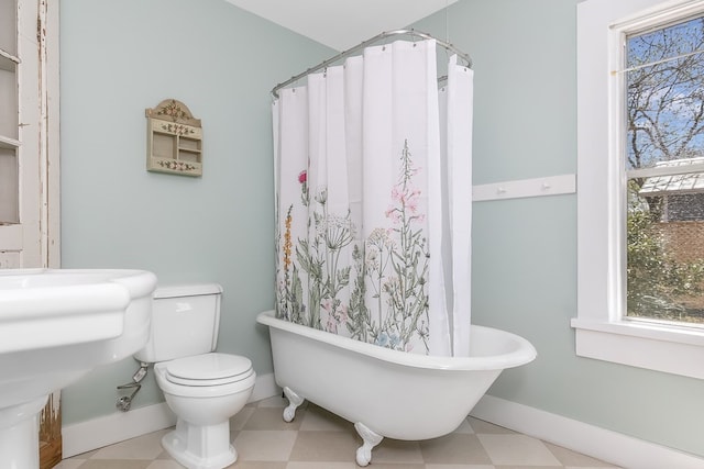 bathroom featuring a tub and toilet