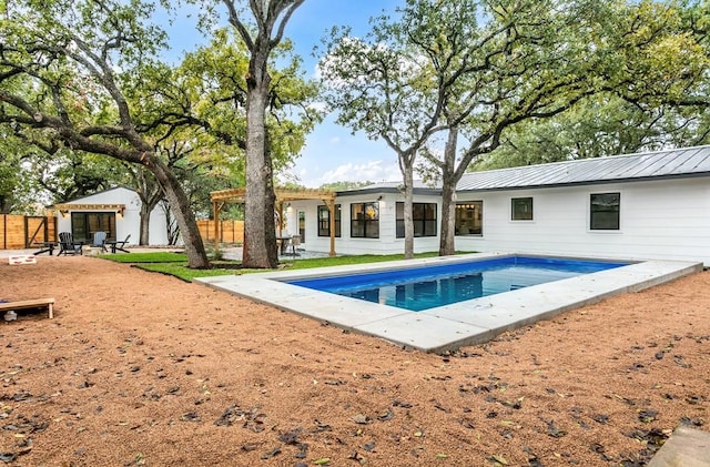 view of pool with an outbuilding and a patio