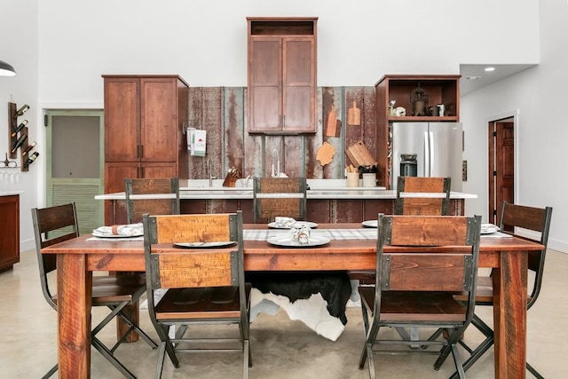 dining room featuring a towering ceiling