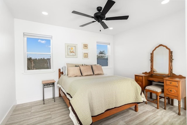 bedroom featuring multiple windows and ceiling fan