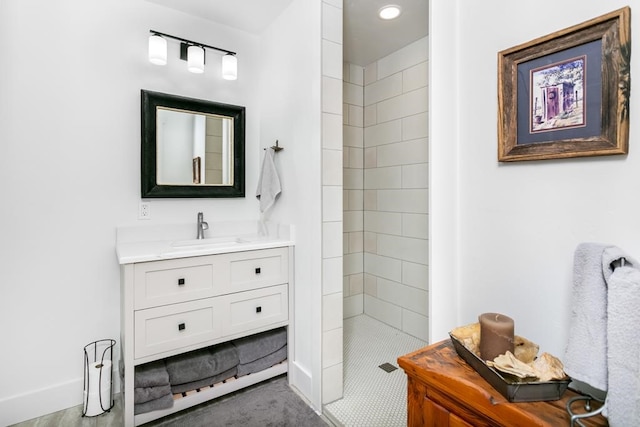 bathroom with vanity and tiled shower