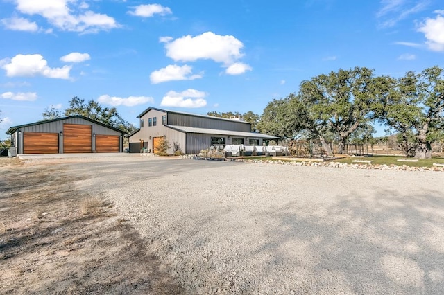 view of front of property with a garage and an outdoor structure