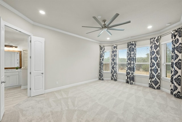 interior space with crown molding, light carpet, and ceiling fan