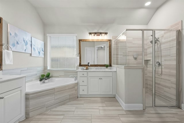 259 N Sage Holw, Dripping Springs, TX 78620 - full bath featuring two vanities, a stall shower, a bath, and vaulted ceiling