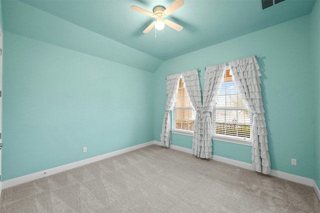 spare room with ceiling fan, light colored carpet, and lofted ceiling