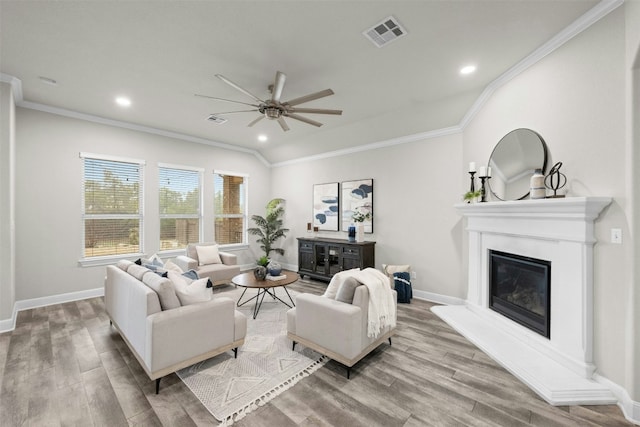 259 N Sage Holw, Dripping Springs, TX 78620 - living room with a ceiling fan, wood finished floors, a glass covered fireplace, crown molding, and baseboards