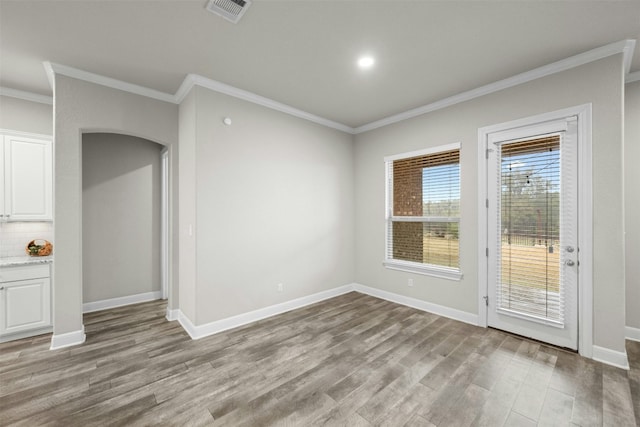 interior space with crown molding and light hardwood / wood-style floors