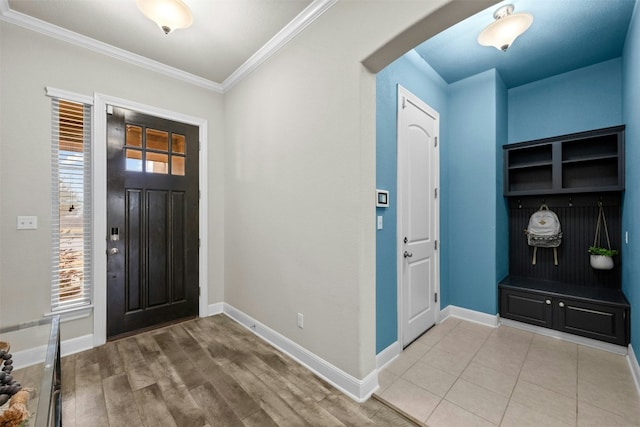 foyer with ornamental molding, plenty of natural light, and hardwood / wood-style floors