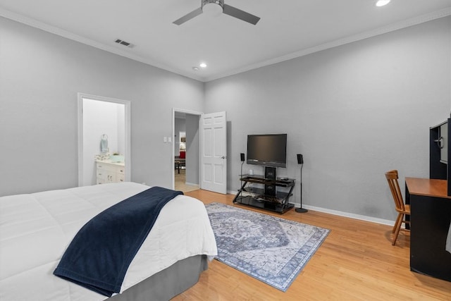 bedroom featuring ceiling fan, ornamental molding, wood-type flooring, and connected bathroom