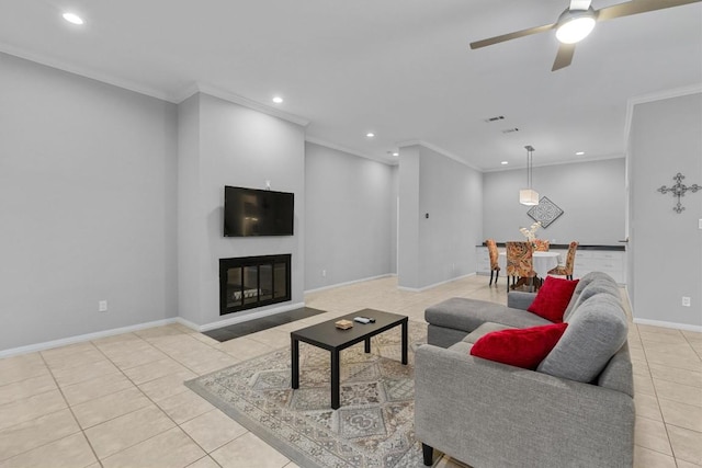 living room with ornamental molding, light tile patterned floors, and ceiling fan