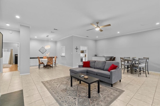 living room featuring ornamental molding, ceiling fan, and light tile patterned flooring