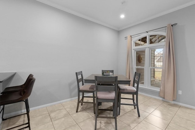 dining space featuring light tile patterned floors and crown molding