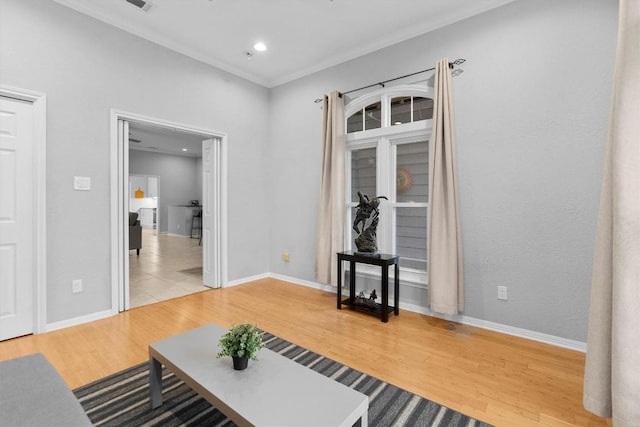 sitting room featuring hardwood / wood-style flooring and ornamental molding