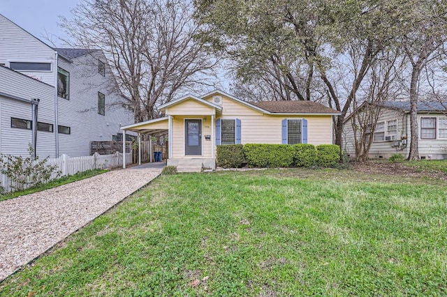 view of front of house with a carport and a front lawn