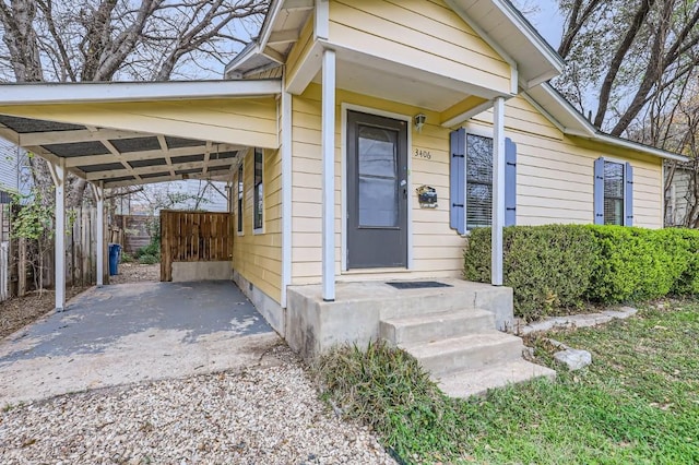 doorway to property featuring a carport