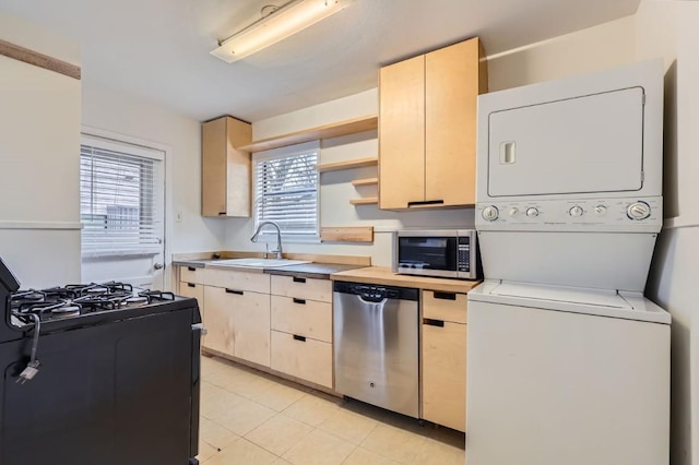 kitchen with stacked washer and dryer, light tile patterned floors, sink, stainless steel appliances, and light brown cabinets