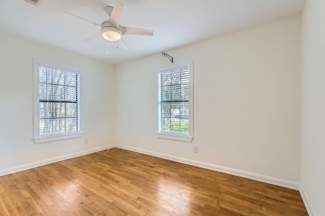 empty room with wood-type flooring and ceiling fan