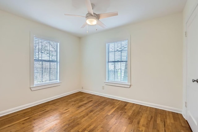 empty room featuring ceiling fan and hardwood / wood-style floors