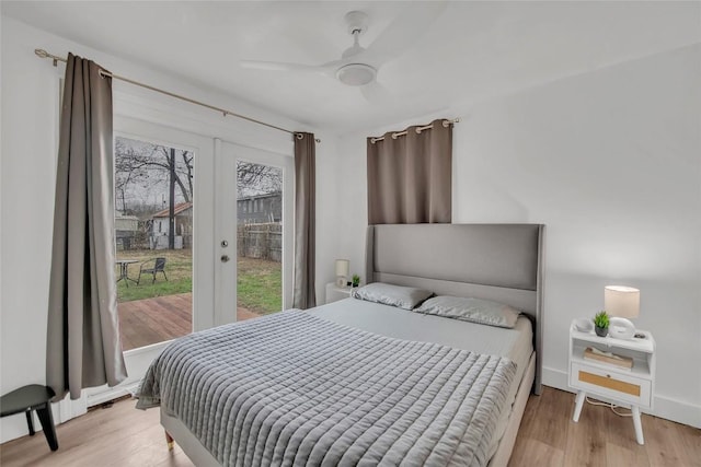 bedroom with french doors, ceiling fan, and light hardwood / wood-style flooring