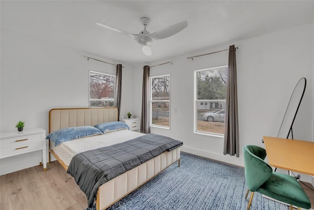 bedroom with light hardwood / wood-style floors and ceiling fan