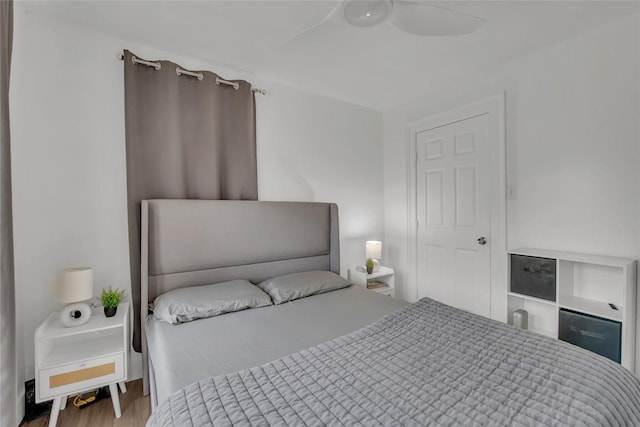 bedroom with wood-type flooring and ceiling fan