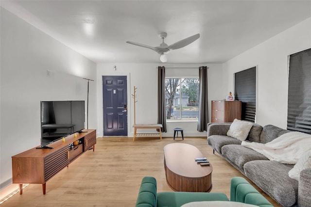 living room featuring ceiling fan and light wood-type flooring