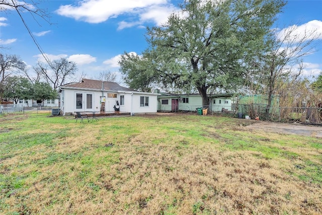 back of house with a lawn