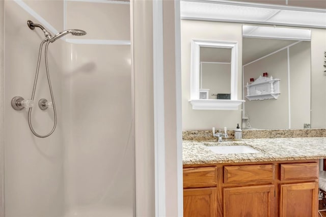 bathroom with walk in shower and vanity