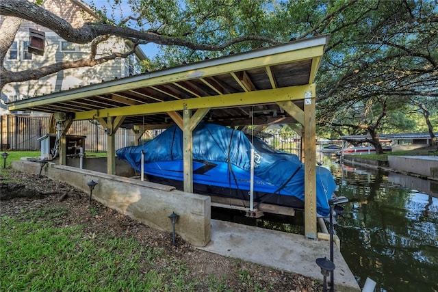 exterior space featuring a water view and a boat dock