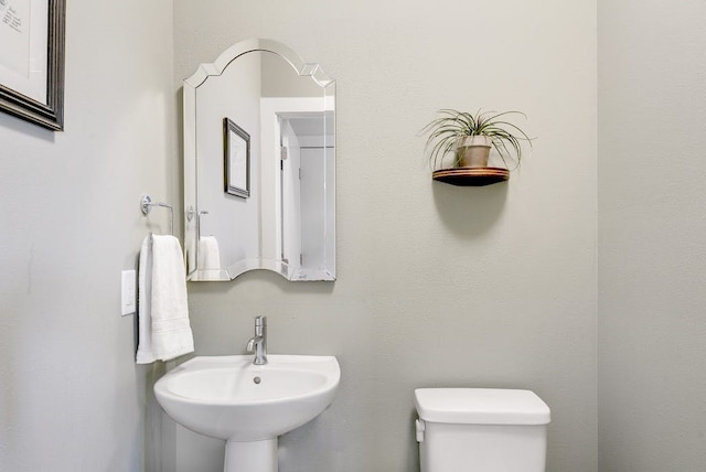 bathroom featuring toilet and a sink