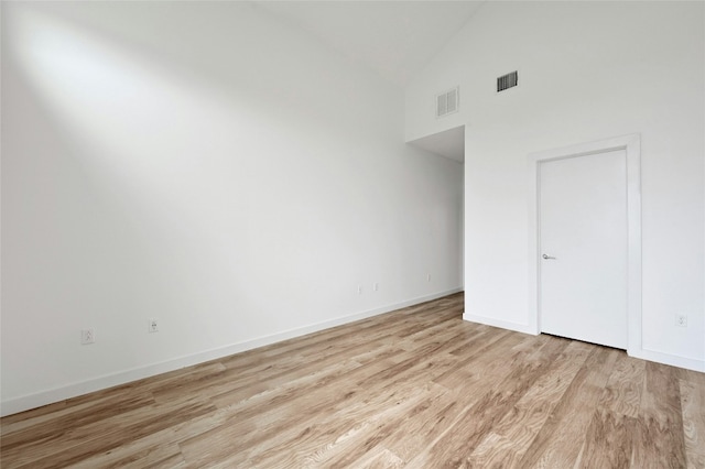 unfurnished bedroom featuring visible vents, baseboards, and wood finished floors