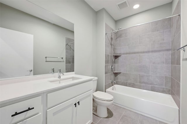 bathroom featuring vanity, visible vents, tile patterned flooring, toilet, and shower / bathtub combination