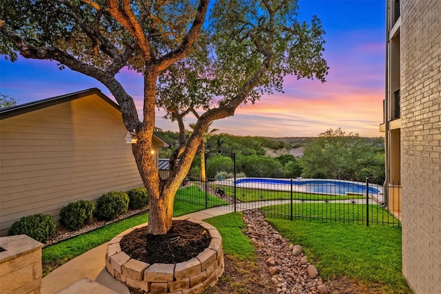 view of yard with a fenced in pool and fence