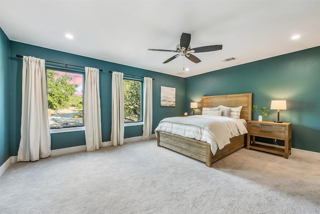 carpeted bedroom with vaulted ceiling and ceiling fan