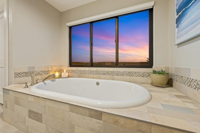 bathroom with a relaxing tiled tub