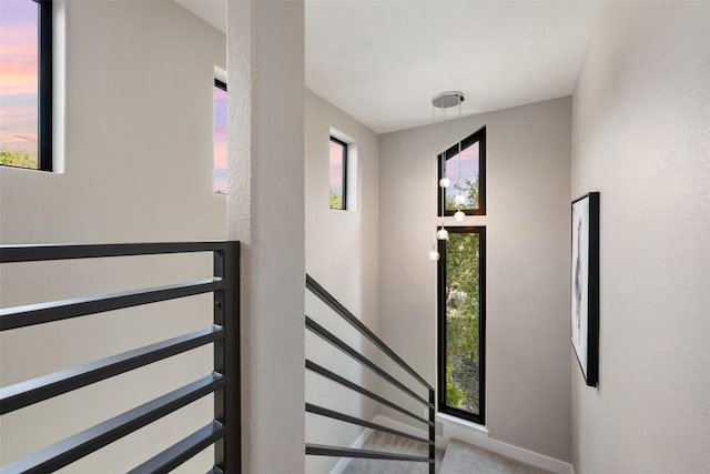 staircase with baseboards and a wealth of natural light