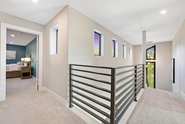 hall with light carpet, recessed lighting, an upstairs landing, and baseboards