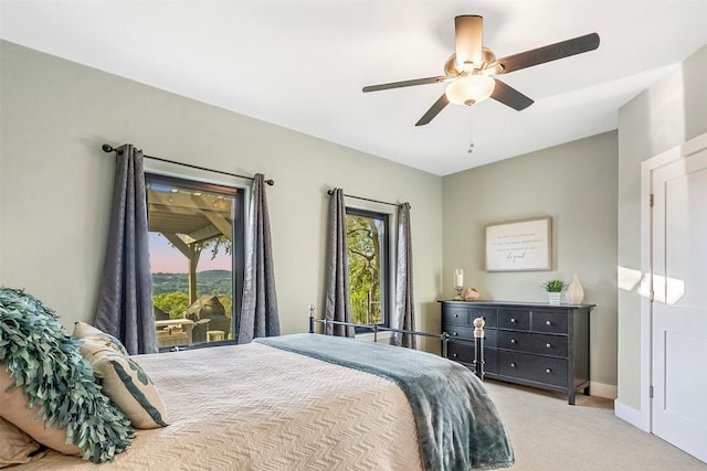 bedroom with ceiling fan and light carpet