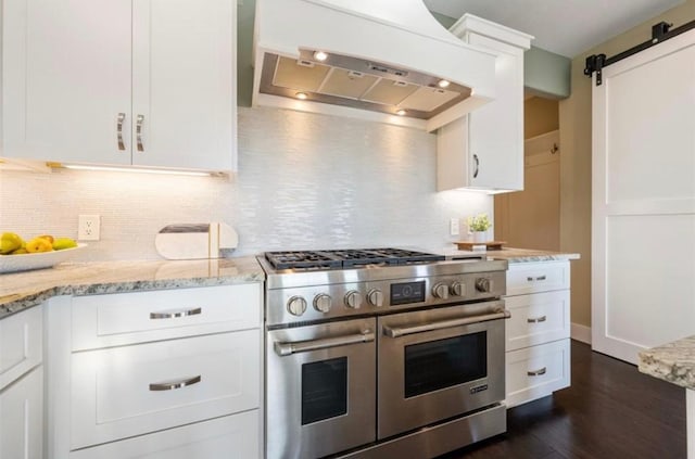 19407 White Horse Cv, Spicewood, TX 78669 - kitchen featuring double oven range, custom range hood, a barn door, dark wood-style flooring, and backsplash