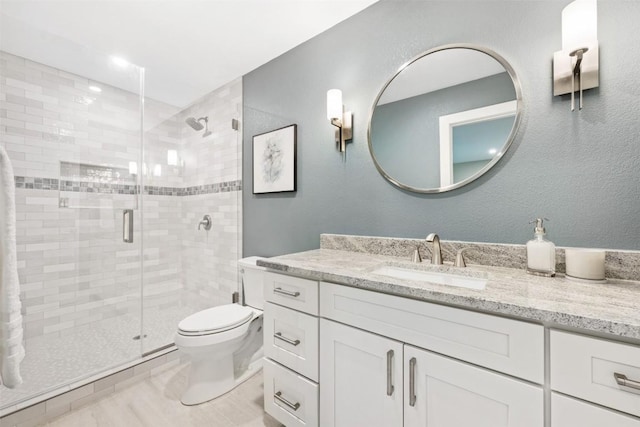 19407 White Horse Cv, Spicewood, TX 78669 - full bathroom featuring vanity, a stall shower, and toilet