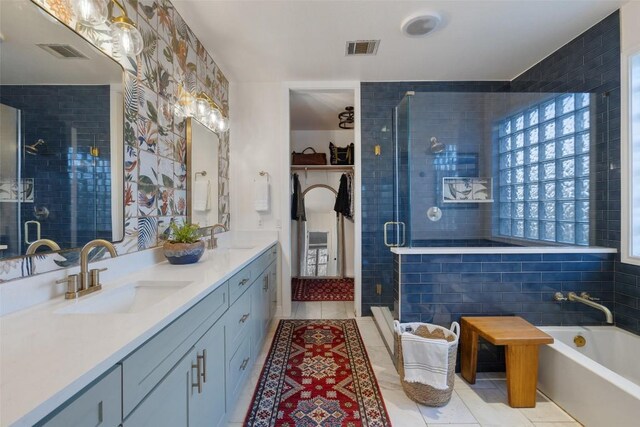 full bath featuring a stall shower, a sink, visible vents, and tile patterned floors