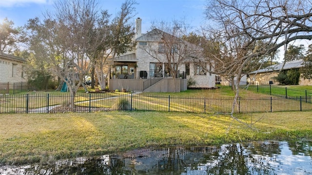 view of yard featuring a water view and fence